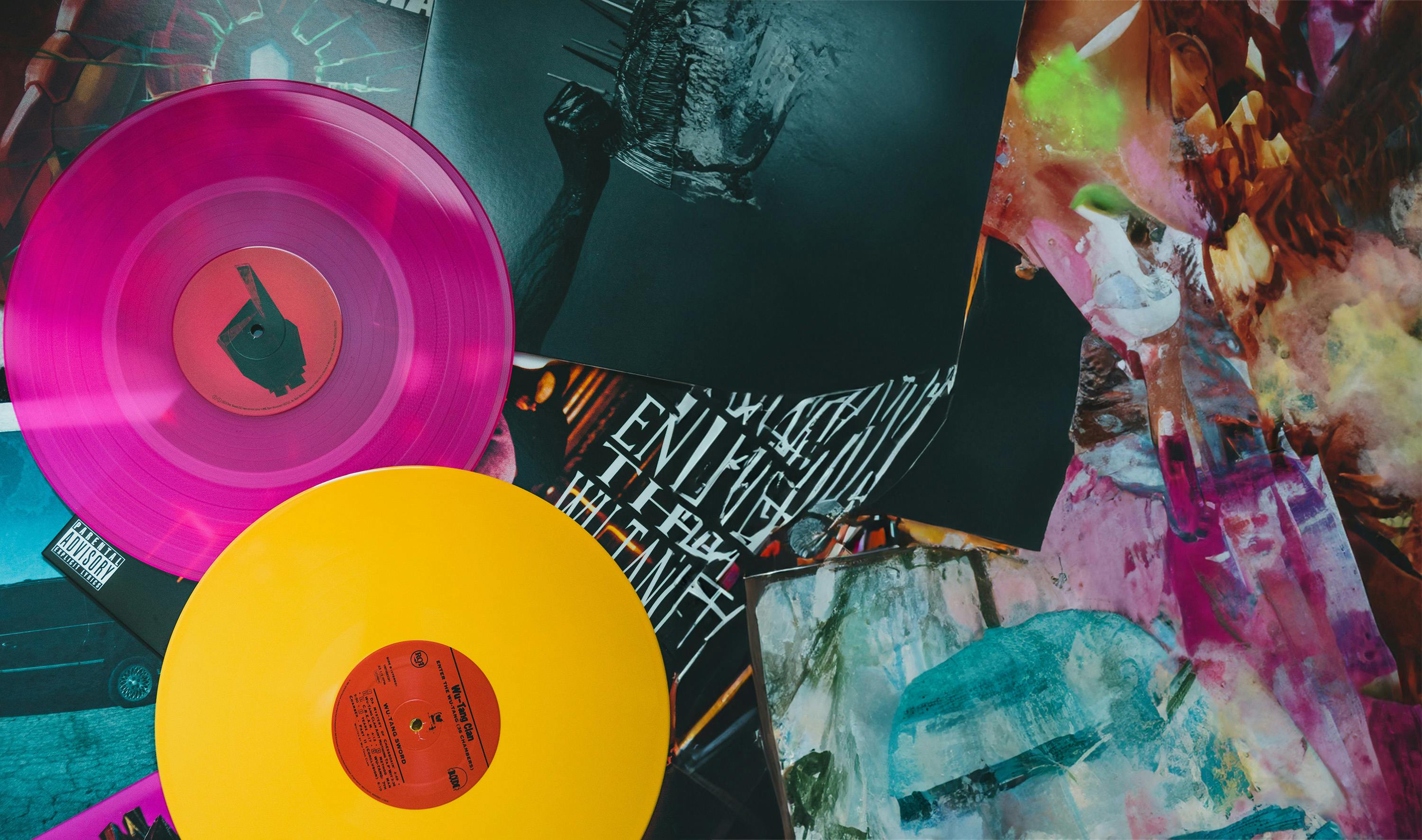 Two vinyl discs on a messy creative desk